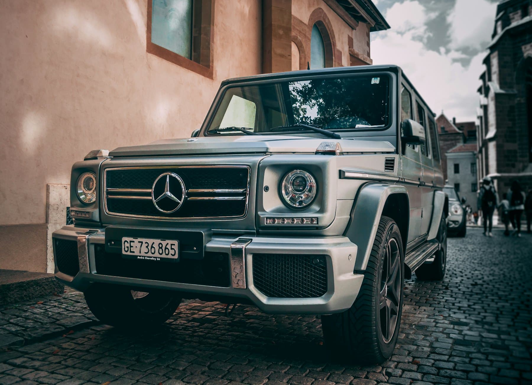 Silver Mercedes-AMG G 63 parked on a cobbled street