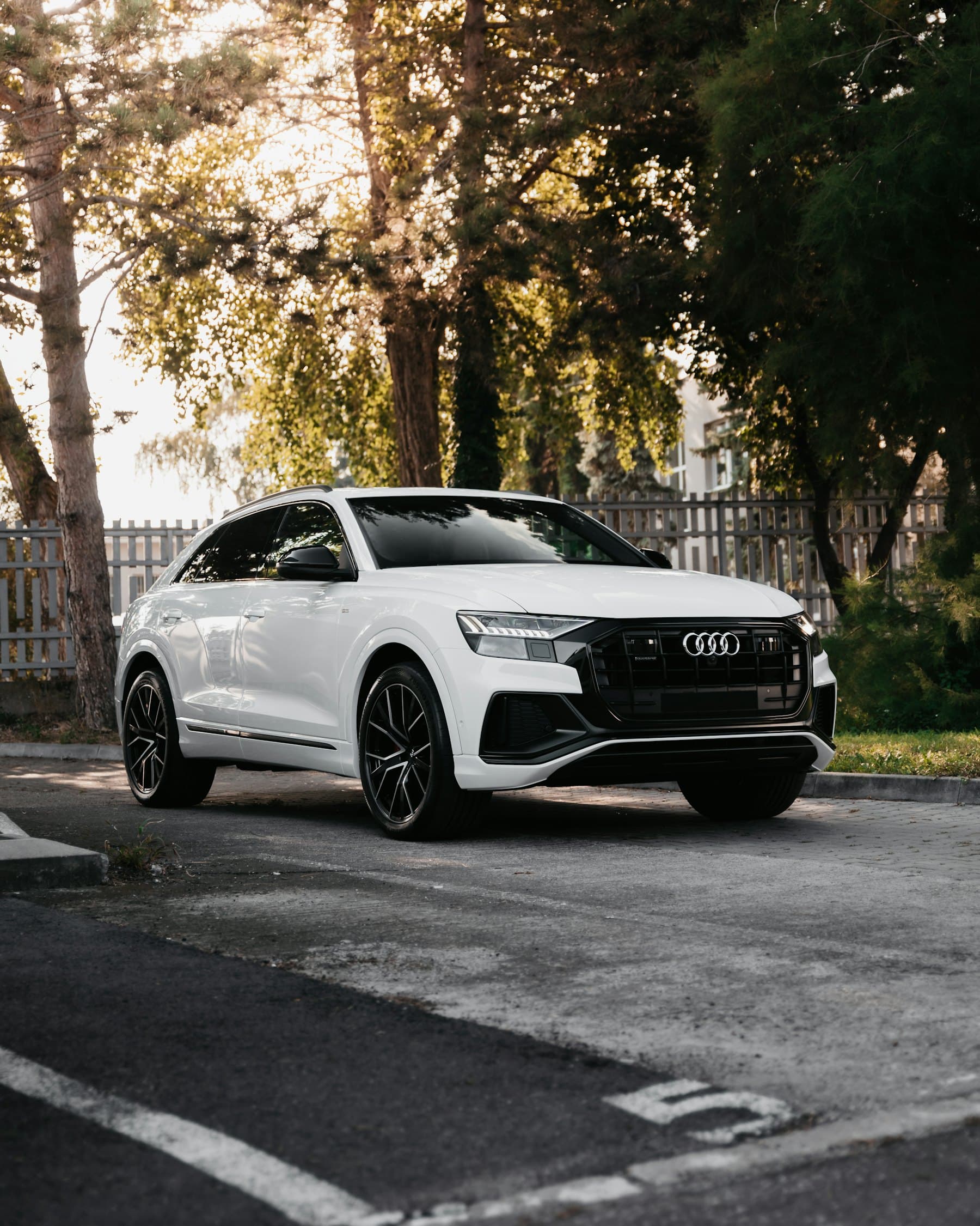 White Audi Q8 parked on a quiet residential street