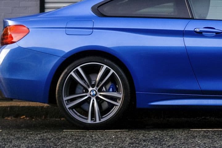 Front wheel and blue M Sport brake caliper on the BMW 440i