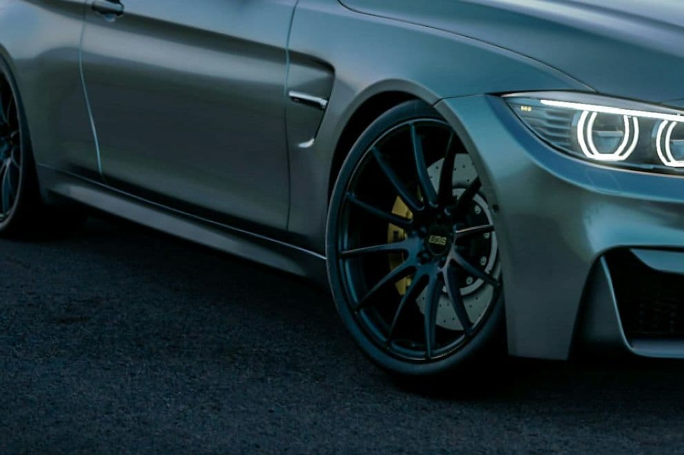 Side detail of the grey BMW M4 showing its dark forged wheel