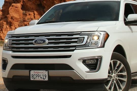Chrome grille and headlight detail of the white Ford Expedition
