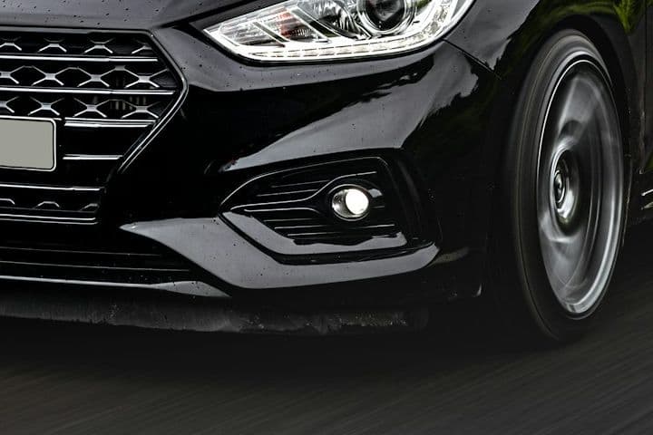 Front corner detail of the black Hyundai Accent