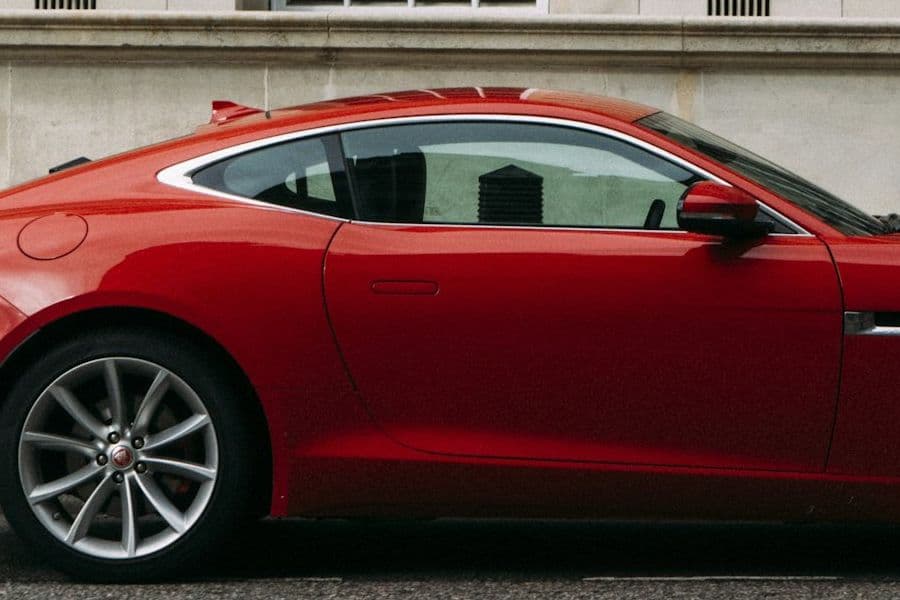 Side window line and rear haunch of the red Jaguar F-Type