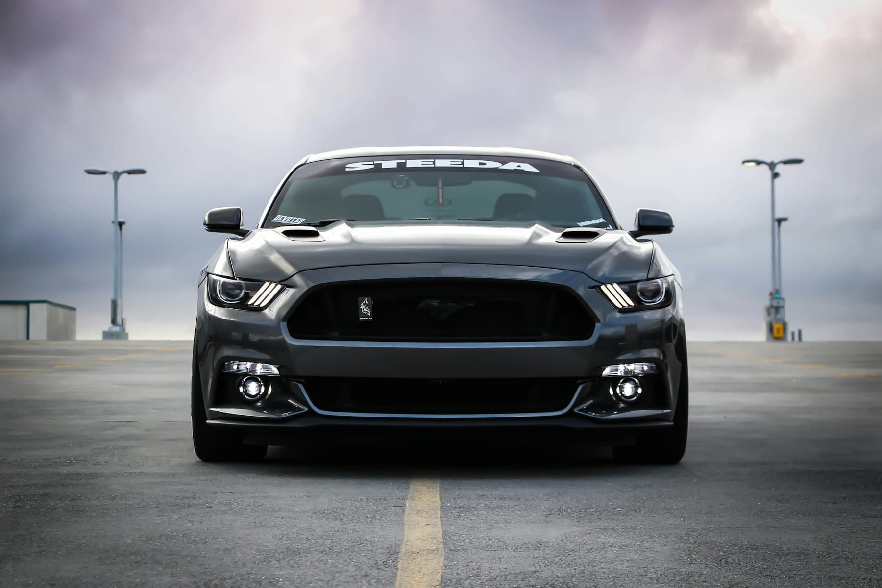 Grey Ford Mustang GT viewed head-on in an empty car park