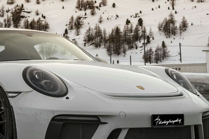 Close detail of the white Porsche 911 GT3 front bumper and headlight