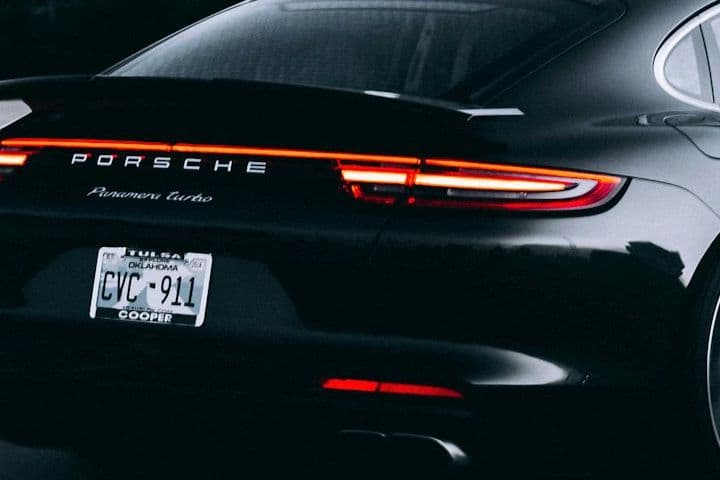 Rear detail of the black Porsche Panamera showing its light bar and badging