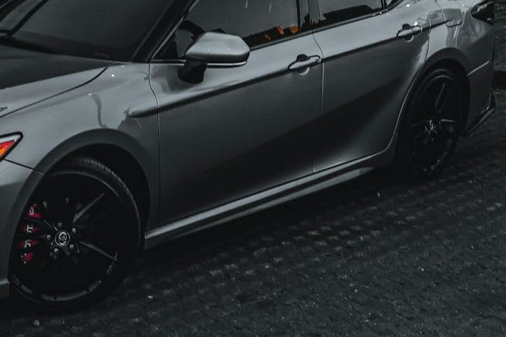 Side detail of the grey Toyota Camry with black wheel