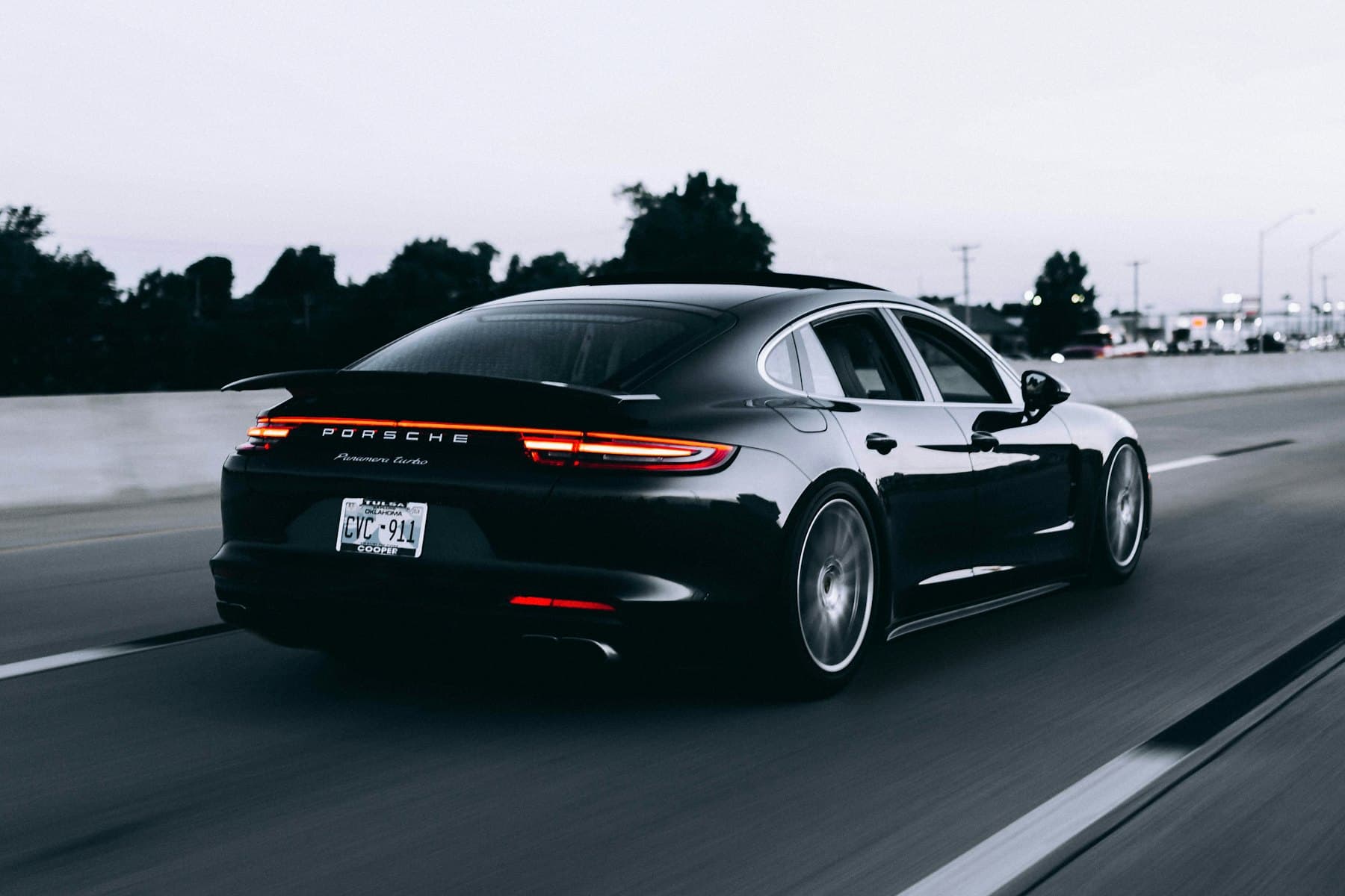 Black Porsche Panamera driving on an open highway